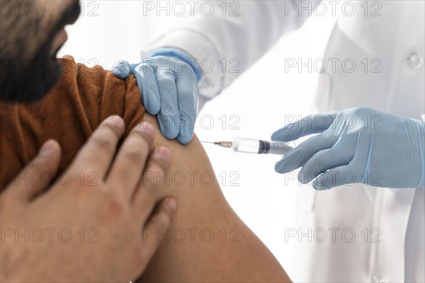 Man being vaccinating by doctor close up