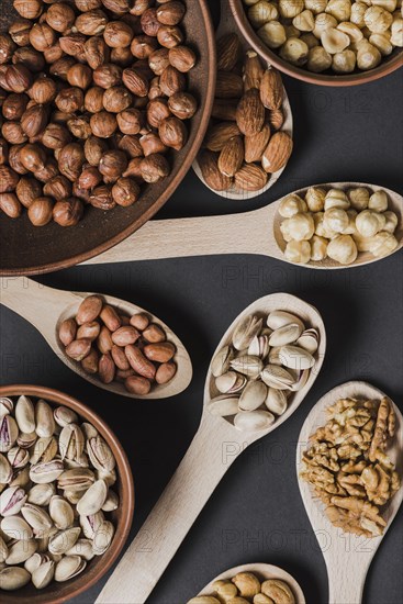 Close up spoons bowls with nuts