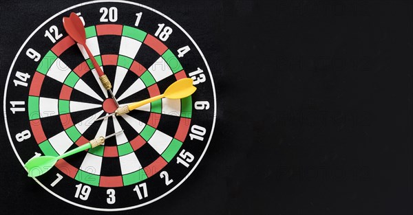 Flat lay darts table black background with copy space