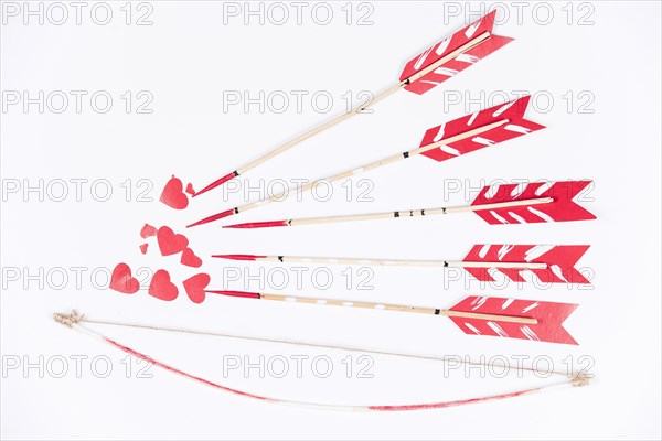 Love arrows aiming small red hearts