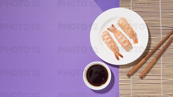 Top view delicious sushi with soy sauce table