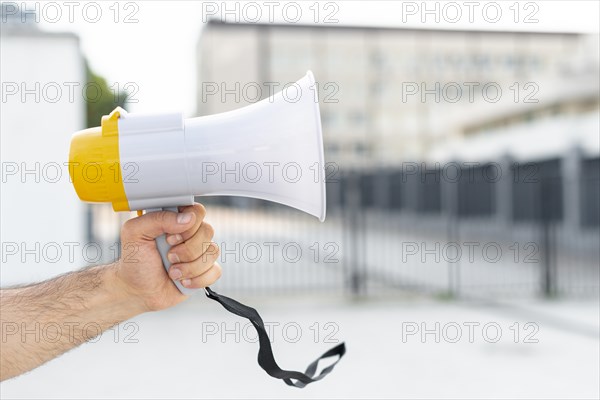 Close up protester holding megaphone