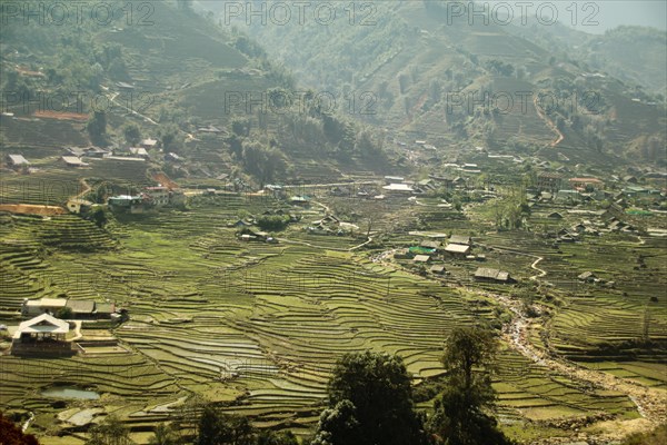 Aerial view fog over the terraced rice paddy and mountains in the village of Lao Cai in Sa pa Vietnam