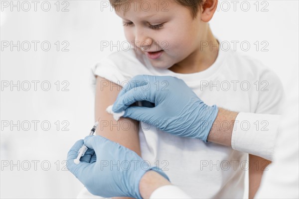 Close up little boy getting vaccine