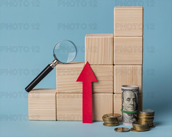 Wooden blocks with magnifying glass growth arrow
