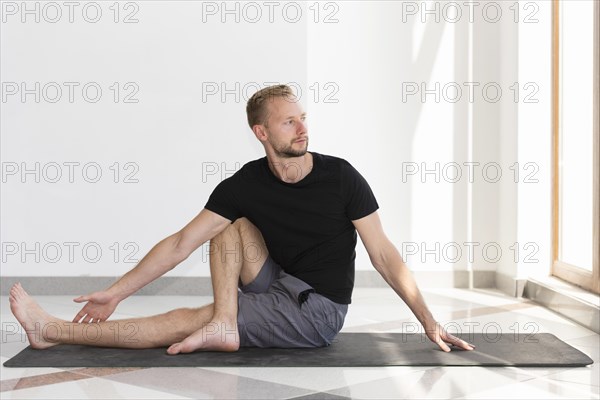 Full shot man stretching indoor