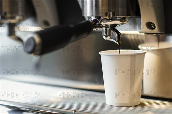 Machine pouring coffee disposable cup