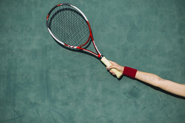 Woman holding tennis racket hand