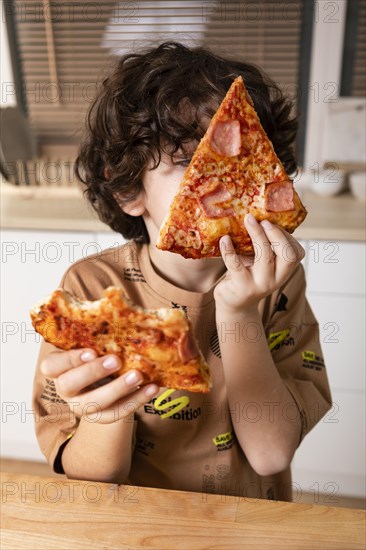 Kid eating pizza home