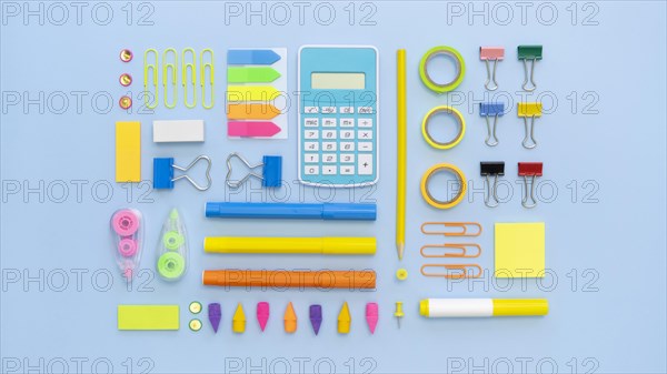 Top view colorful office stationery with calculator paper clips