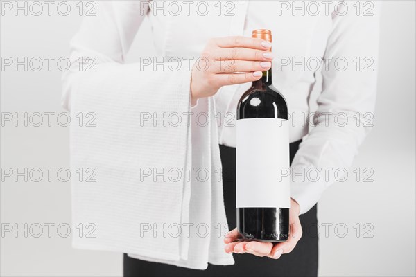 Waiter holding offering bottle wine