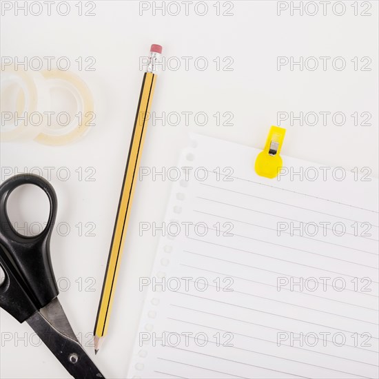 Close up single page pencil scissors cello tape white background