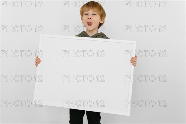 Medium shot kid holding board