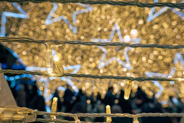 Christmas illumination LED lights garlands close up with stars in background