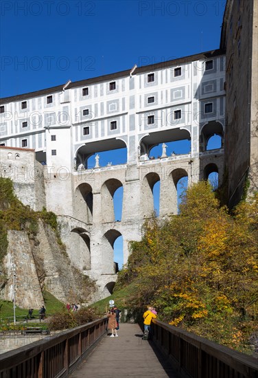 Pedestrian bridge over the Vltava with Mantle Bridge and Krumlov Castle