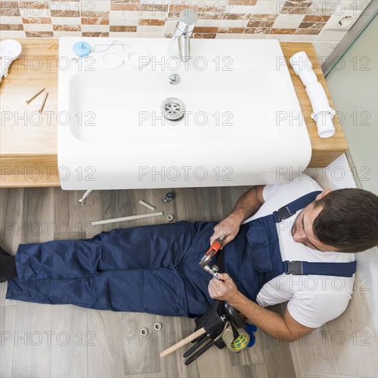 Sanitary technician working with sink