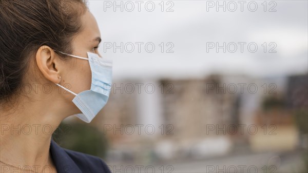 Sideways woman with medical mask with copy space