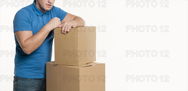 Front view delivery man cardboard boxes