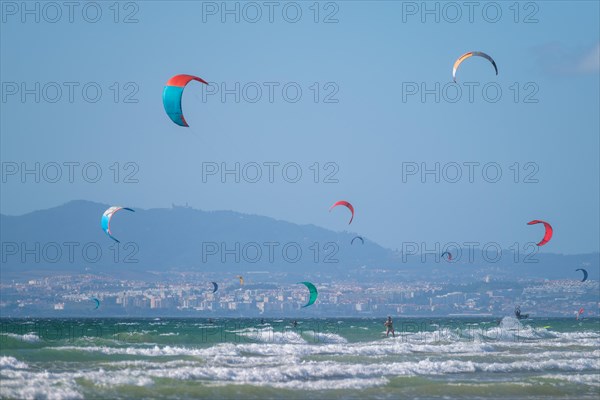 Kiteboarding kitesurfing kiteboarder kitesurfer kites on the Atlantic ocean beach at Fonte da Telha beach