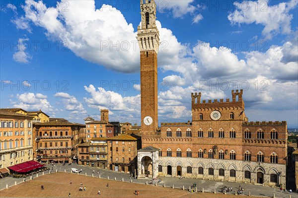 Spring clouds over the Piazza del Campo with the bell tower Torre del Mangia and the town hall Palazzo Pubblico