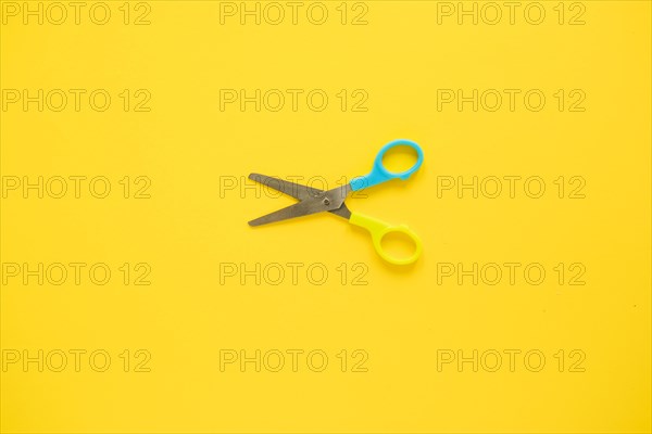 Opened scissors laid middle