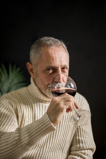 Senior man drinking red wine