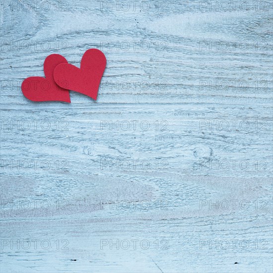 Two red hearts wooden table