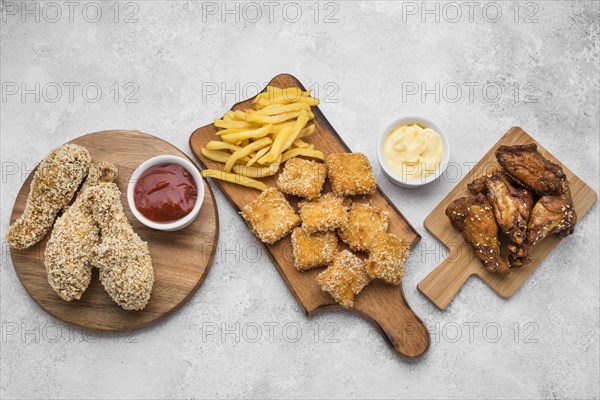 Top view fried chicken nuggets sauces chopping boards