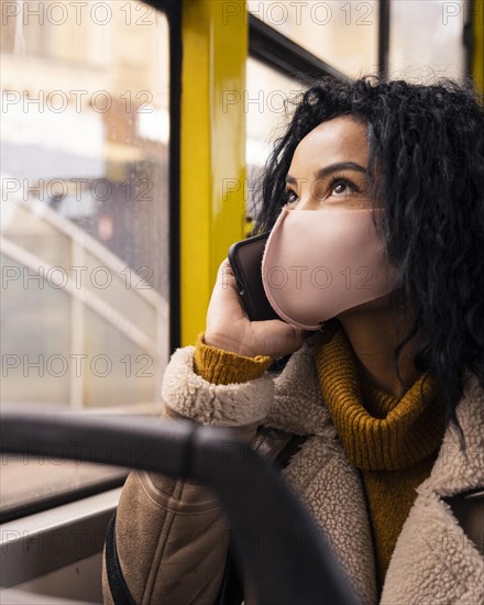 Beautiful woman talking phone bus