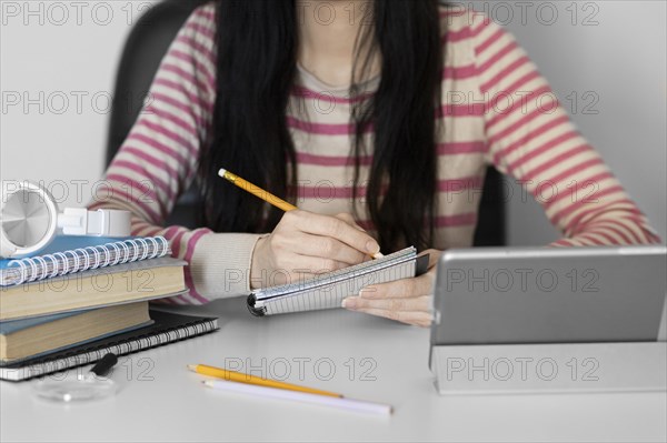 Close up woman taking notes