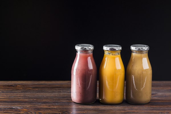 Smoothie bottles wooden surface