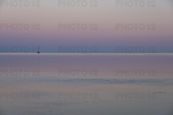 Ship in the Wadden Sea at sunset