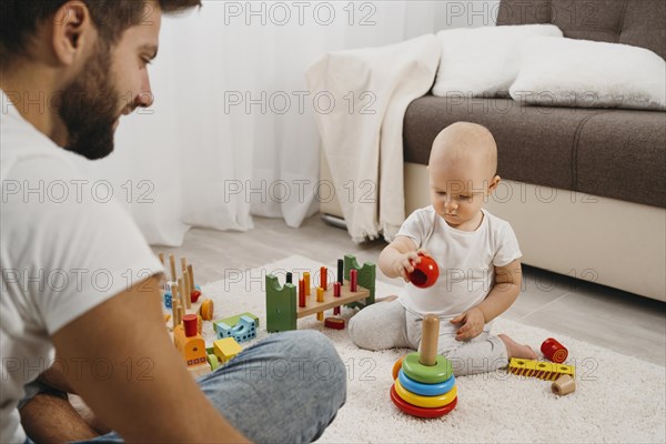 Baby home playing with his father