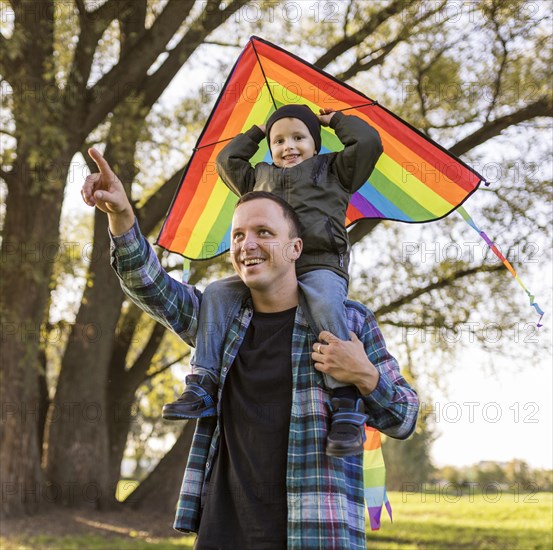 Father son holding kite park