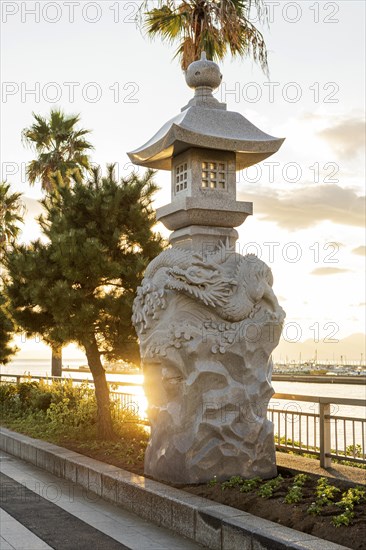 Stone lanterns with dragons in the evening light