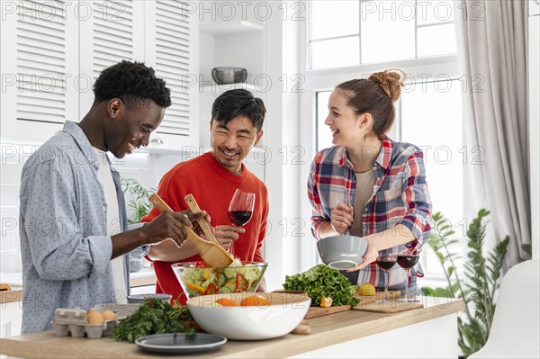 Happy roommates kitchen cooking