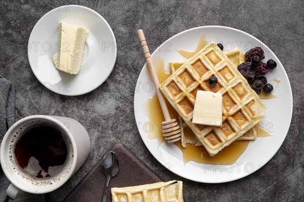 Top view waffles plate with butter cup tea