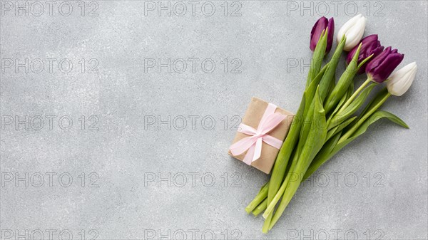 Bouquet tulips with wrapped gift copy space