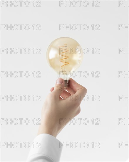 Close up hand holding light bulb