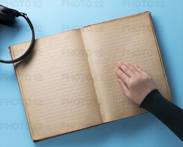 Braille book blue background flat lay
