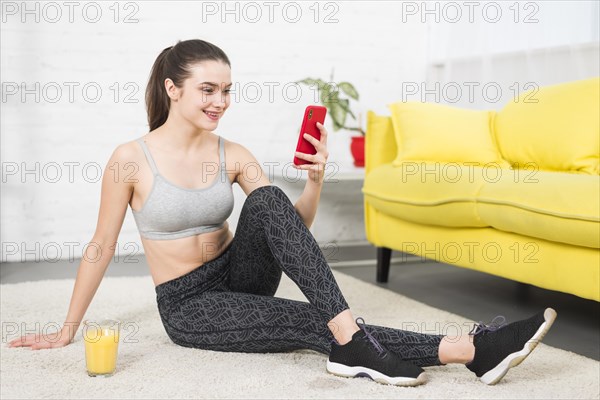 Fitness girl using her mobile phone