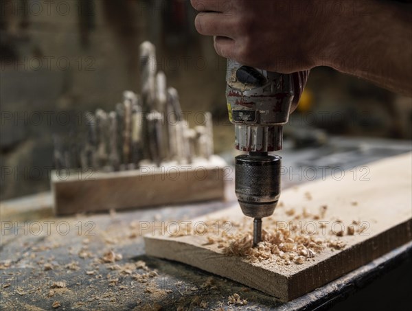 Man with drill working with wood