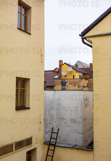 Stepladder leaning against a backyard facadein the historic old town of Ceske Budejovice