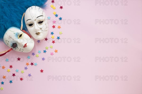 Venetian masks near feathers stars