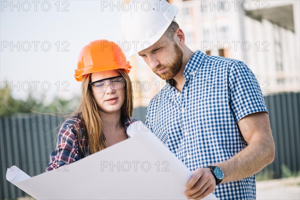 Builder woman man blueprint