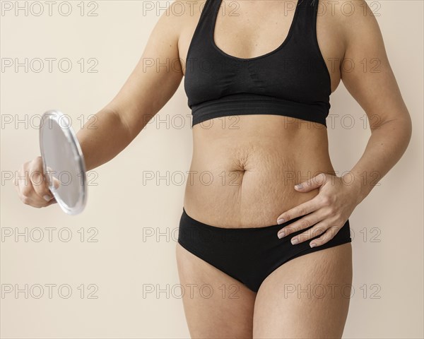 Close up woman holding mirror