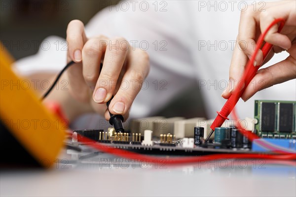 Front view female technician with computer motherboard