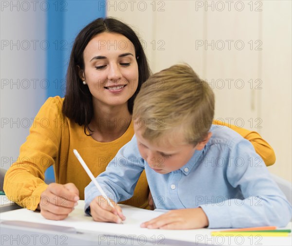 Front view woman helping her student class