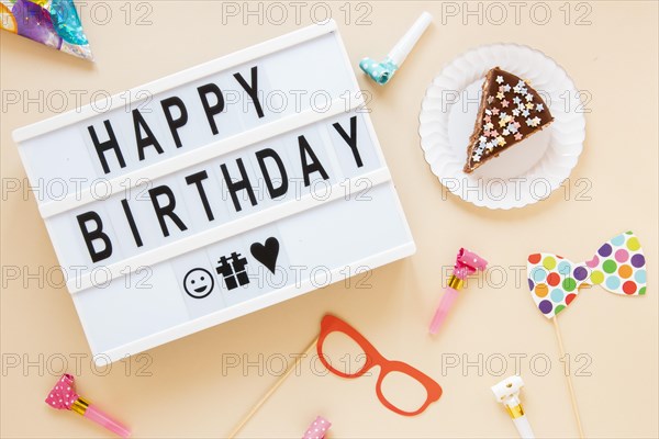 Composition with sliced cake birthday lettering