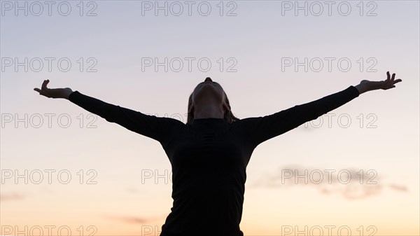 Front view woman standing with her arms up